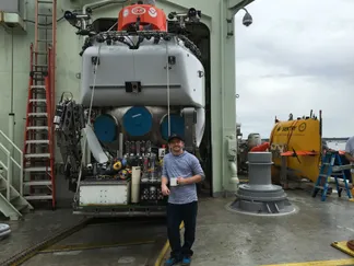 Sean Jungbluth alongside the Alvin submersible and Sentry AUV